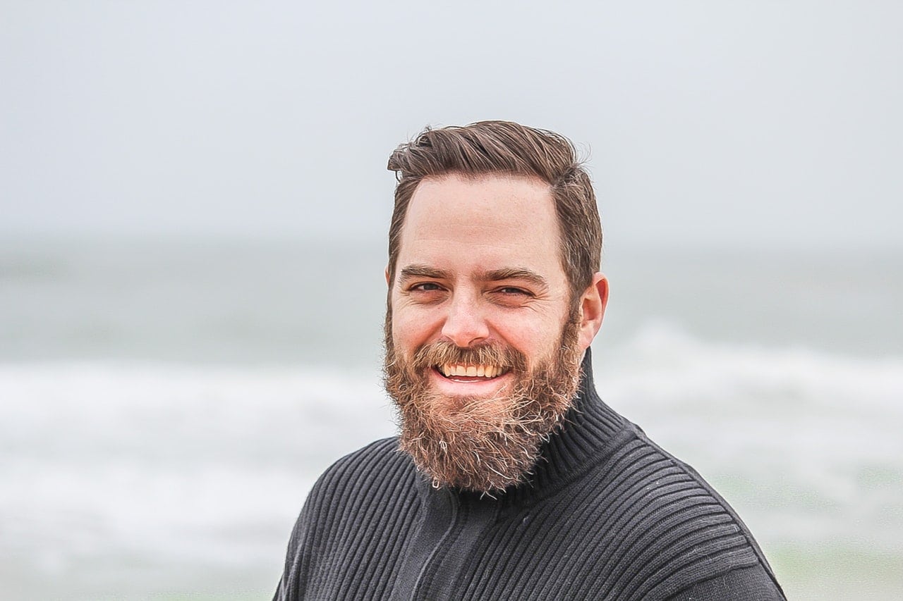 Bearded Man in Midlife Transformation on a Beach.