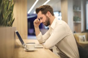 man overwhelmed at work college stressed unhappy (1) man overwhelmed at work college stressed unhappy (1)